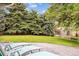 Serene backyard featuring a patio area with lounge chairs, lush lawn, and mature trees at 6068 S Clayton St, Centennial, CO 80121