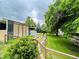 Lush backyard featuring a well-maintained lawn, mature trees, and wood retaining wall at 6068 S Clayton St, Centennial, CO 80121