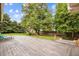 Spacious backyard patio area perfect for outdoor entertaining, complete with mature trees and landscaping at 6068 S Clayton St, Centennial, CO 80121