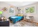 Comfortable bedroom with natural light, a desk, and a stylish, neutral-toned rug at 6068 S Clayton St, Centennial, CO 80121