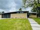 Single-story home with a modern design, brick facade, and well-manicured lawn at 6068 S Clayton St, Centennial, CO 80121