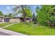 Single-story home with modern design, landscaped front yard, and mature trees at 6068 S Clayton St, Centennial, CO 80121