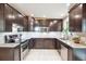 Stylish kitchen featuring granite countertops, stainless steel appliances, and dark wood cabinetry at 6068 S Clayton St, Centennial, CO 80121