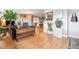 Bright living room with hardwood floors, a brick fireplace, and an open layout at 6068 S Clayton St, Centennial, CO 80121