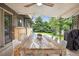 Relaxing outdoor dining area with a wooden table, chairs, and a grill, perfect for entertaining at 6068 S Clayton St, Centennial, CO 80121