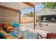 Cozy patio with stone wall, comfortable seating, and an open view of the backyard at 6068 S Clayton St, Centennial, CO 80121