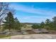 Scenic backyard view from the patio showcases the rolling landscape and natural surroundings at 25803 Aspen Way, Golden, CO 80401