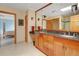 A bathroom featuring double sinks, wooden cabinets, an oversized mirror, and a walk-in shower at 25803 Aspen Way, Golden, CO 80401