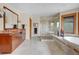 Luxurious bathroom featuring double sinks, a glass shower, and a soaking tub for ultimate relaxation at 25803 Aspen Way, Golden, CO 80401