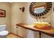 Stylish bathroom with an onyx sink, wood countertop and decorative round mirror at 25803 Aspen Way, Golden, CO 80401
