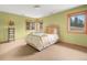 Serene bedroom with a queen bed, neutral tones, and ample natural light from multiple windows at 25803 Aspen Way, Golden, CO 80401