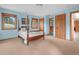 Comfortable bedroom with four-poster bed, soft carpeting, and plenty of natural light at 25803 Aspen Way, Golden, CO 80401
