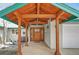 Charming entrance with a wooden pergola, a decorative front door, and seating on the front porch at 25803 Aspen Way, Golden, CO 80401