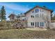 Stunning home exterior featuring multiple windows and private terrace with seating at 25803 Aspen Way, Golden, CO 80401