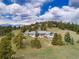 Expansive single Gathering home nestled in a lush forest with a large lawn and beautiful mountain views at 25803 Aspen Way, Golden, CO 80401