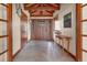 Inviting foyer with a beautiful hardwood door, hardwood floors, transom windows, and a stylish decorative table at 25803 Aspen Way, Golden, CO 80401