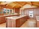 Gourmet kitchen with hardwood floors, granite countertops, a center island, stainless steel appliances, and custom cabinetry at 25803 Aspen Way, Golden, CO 80401