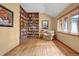 Inviting library space featuring built-in wooden bookshelves and natural light from large windows at 25803 Aspen Way, Golden, CO 80401