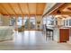 Open-concept living room next to a gourmet kitchen with hardwood floors, views of the forest, and vaulted ceilings at 25803 Aspen Way, Golden, CO 80401