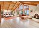 Vaulted ceiling, floor-to-ceiling windows, and fireplace enhance the main bedroom's luxurious feel at 25803 Aspen Way, Golden, CO 80401