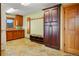 Spacious mudroom with custom cabinets, storage bench, hanging rack, and durable tile flooring at 25803 Aspen Way, Golden, CO 80401