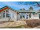 Stone patio provides a relaxing outdoor space with views from the home's multiple large windows at 25803 Aspen Way, Golden, CO 80401