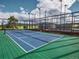 Outdoor tennis court featuring blue court and green surrounding under the blue sky at 25803 Aspen Way, Golden, CO 80401
