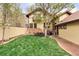 Spacious backyard with lush green lawn, patio, and mature trees at 317 N Lafayette St, Denver, CO 80218