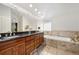 Bathroom with double vanity, large mirror and soaking tub at 317 N Lafayette St, Denver, CO 80218