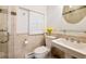 Cozy bathroom with tiled walls, white fixtures, a glass shower, and a shuttered window at 317 N Lafayette St, Denver, CO 80218