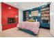 Stylish bedroom featuring a red tiled fireplace and custom built-in bookshelves at 317 N Lafayette St, Denver, CO 80218