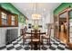 Open dining room with black and white checkered floors and a dining table leading to the kitchen at 317 N Lafayette St, Denver, CO 80218