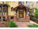 Close-up of the home's entryway, with a brick path and ornate architectural details at 317 N Lafayette St, Denver, CO 80218