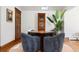 Inviting game room with comfortable chairs, hardwood floors, a grandfather clock, and a natural plant at 317 N Lafayette St, Denver, CO 80218