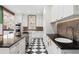 Stylish kitchen showcasing black countertops, white cabinets, and a black and white tile floor at 317 N Lafayette St, Denver, CO 80218
