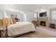 Bedroom with fireplace, TV, desk and large windows for ample natural light at 317 N Lafayette St, Denver, CO 80218