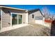 Back exterior featuring a sliding glass door and a small storage shed at 5032 Nighthawk Pkwy, Brighton, CO 80601