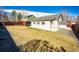 Backyard view of the back of the home and a storage shed at 5032 Nighthawk Pkwy, Brighton, CO 80601