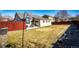 Backyard view of the home with outdoor seating and a built-in grill area at 5032 Nighthawk Pkwy, Brighton, CO 80601