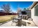 Backyard patio featuring a table and chairs, built-in grill, and exterior TV at 5032 Nighthawk Pkwy, Brighton, CO 80601
