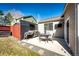 Backyard patio with outdoor table and chairs, and a built-in grill area at 5032 Nighthawk Pkwy, Brighton, CO 80601