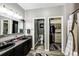 Modern bathroom featuring double sinks, granite countertop, and a walk-in closet at 5032 Nighthawk Pkwy, Brighton, CO 80601