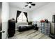 Inviting bedroom with a ceiling fan, large window, and neutral color scheme at 5032 Nighthawk Pkwy, Brighton, CO 80601