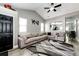 Open-concept living room boasting a large sectional sofa and view into dining area at 5032 Nighthawk Pkwy, Brighton, CO 80601