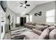 Spacious living room featuring vaulted ceilings and a stylish rug at 5032 Nighthawk Pkwy, Brighton, CO 80601