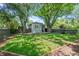 The fenced back yard features lush green space and mature trees at 864 Garfield St, Denver, CO 80206