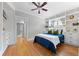 Comfortable bedroom featuring hardwood floors, built-in shelving, and ensuite bath at 864 Garfield St, Denver, CO 80206