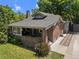 Charming brick home with covered front porch and mature landscaping at 864 Garfield St, Denver, CO 80206