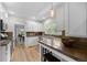 Bright kitchen with stone countertops, white cabinets, stainless steel appliances, and hardwood floors at 864 Garfield St, Denver, CO 80206