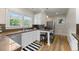 Bright eat-in kitchen with stainless steel appliances, granite countertops, and hardwood floors at 864 Garfield St, Denver, CO 80206